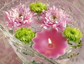 Chrysanthemum and button pom floating candle centerpiece Chrysanthemum and button pom floating candle centerpiece