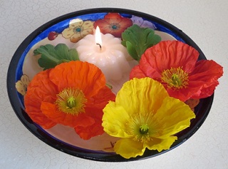 Floating poppy flowers and candle Floating poppy flowers and candle